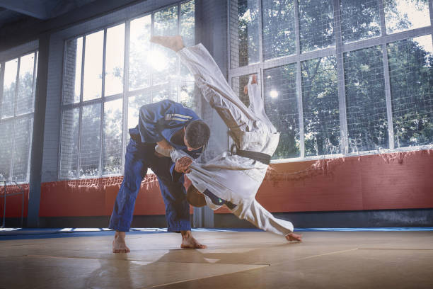 istock Two judo fighters showing technical skill while practicing martial arts in a fight club 1018245334