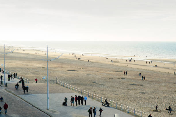 istock people walking on sea-wall 1018246812