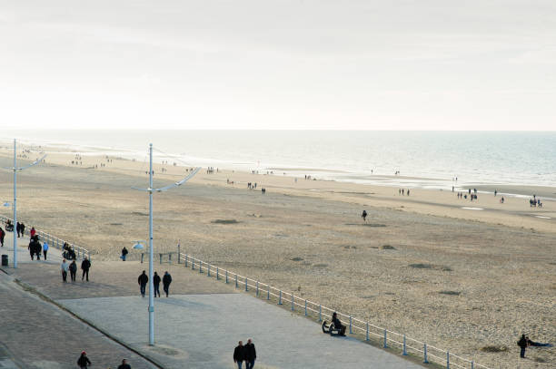 istock people walking on sea-wall 1018246816