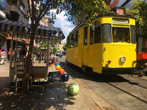 Kadikoy, Istanbul, Turkey - August 8, 2018: Nostalgic tramway and street food seller in Bahariye Street.