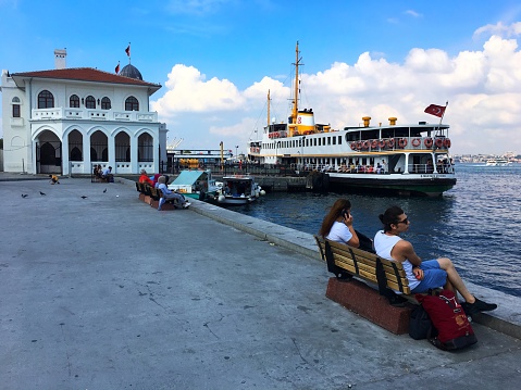 Kadikoy, Istanbul, Turkey - August 8, 2018: People are watching the Marmara Sea just beside the Prince's Islands Pier.