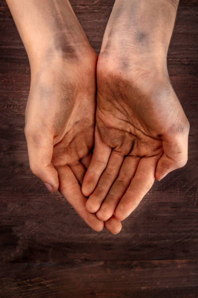 istock Dirty child's hands, begging for money, poverty symbol, with copy space 1018266514