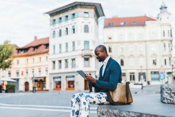 istock African American man using a digital tablet in the city 1018266788