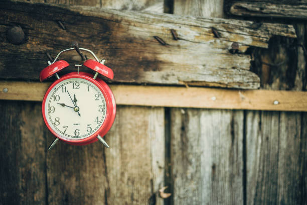 istock Alarm clock on wooden fence 1018267468