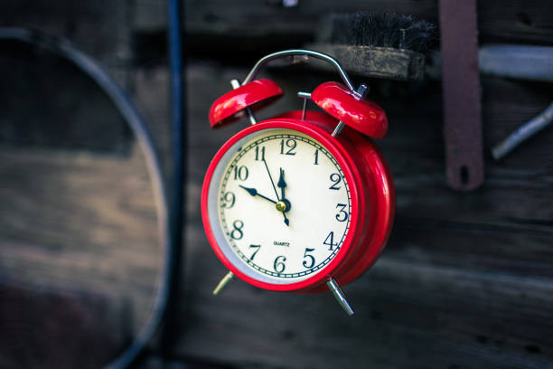 istock Alarm clock on wooden fence 1018272344