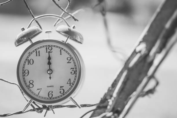 istock Alarm clock hanging on metal fence 1018272648