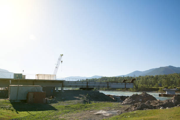 istock Construction of a bridge across a mountain river. 1018273228