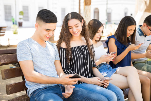 istock Boys and girls using phone outdoors 1018277624