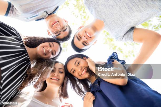 Friends Standing In A Circle Outdoors Stock Photo - Download Image Now - Teenager, Adolescence, Latin American and Hispanic Ethnicity