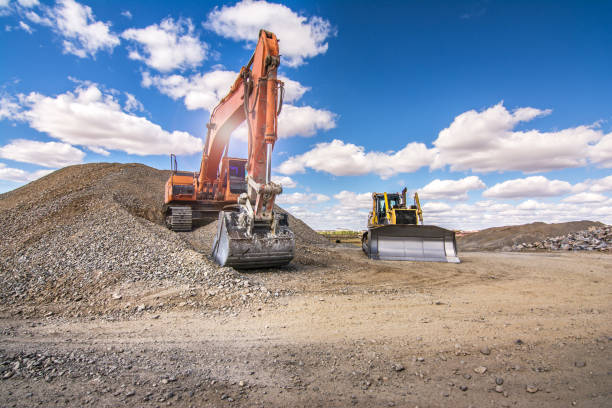 istock Land mine with excavators to extract stone and transform into gravel 1018282060