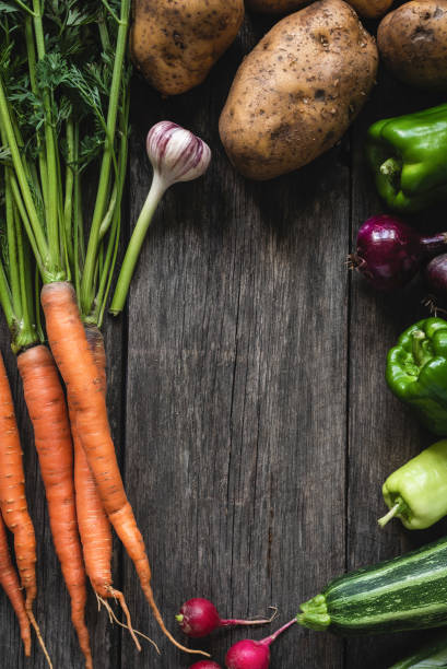 istock Vegetables harvest on wood background. Fresh organic vegetables 1018282824
