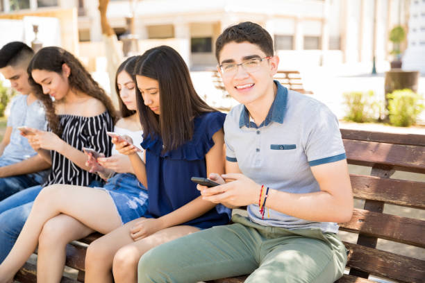 istock Teenager with friends using phones 1018286668
