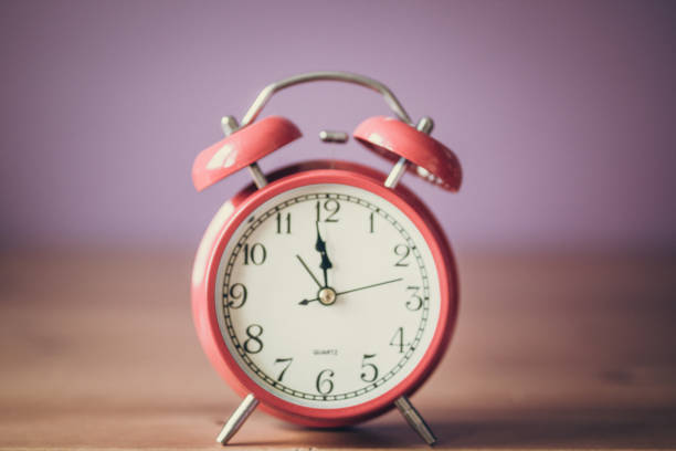 istock Alarm clock on wooden table 1018290842