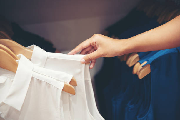 istock hand of customer choosing clothes in the store 1018290850
