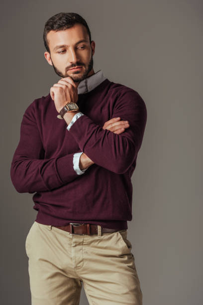 istock handsome bearded man posing in burgundy sweater, isolated on grey 1018293100