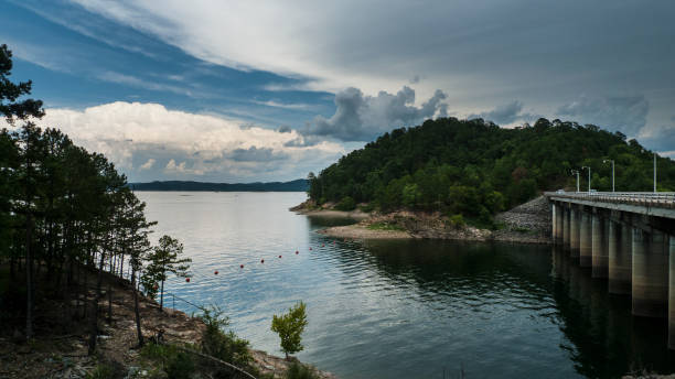 istock Dam and waterway with dramatic clouds and beautiful reflections, Broken Bow Lake, Oklahoma 1018295008