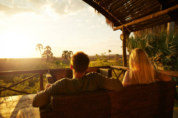 Rearview shot of an unrecognizable couple having a drink outside at a resort in nature