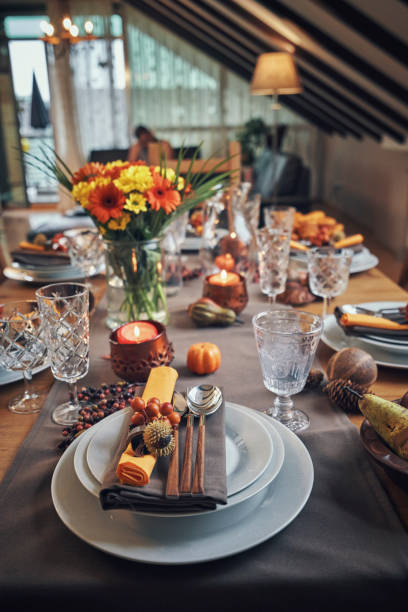 istock Decorated Table for Thanksgiving Dinner with Candles, Pumpkins, Leafs and Nuts 1018301912