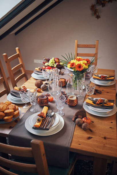 istock Decorated Table for Thanksgiving Dinner with Candles, Pumpkins, Leafs and Nuts 1018301926