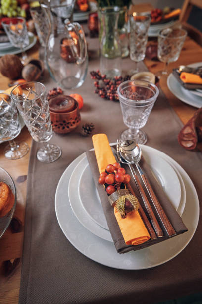 istock Decorated Table for Thanksgiving Dinner with Candles, Pumpkins, Leafs and Nuts 1018301928
