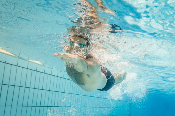 istock Pro freestyle swimmer under water 1018301968