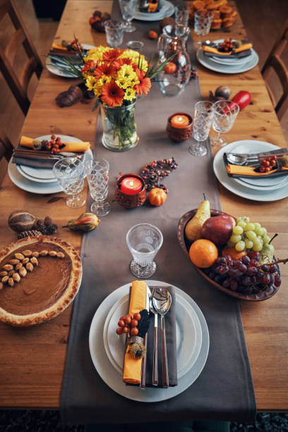 istock Decorated Table for Thanksgiving Dinner with Candles, Pumpkins, Leafs and Nuts 1018301976