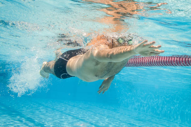 istock Pro freestyle swimmer under water 1018301984