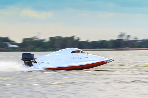 White powerboat go fast along the lake