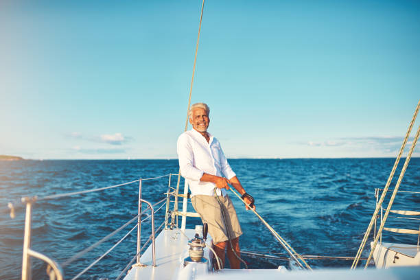 istock Smiling mature man out for a sail on his boat 1018306072