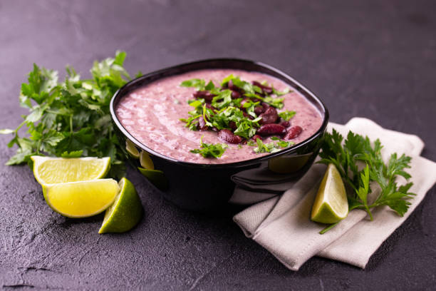 istock Mexican bean puree soup with lime, parsley and chilli pepper. 1018310058