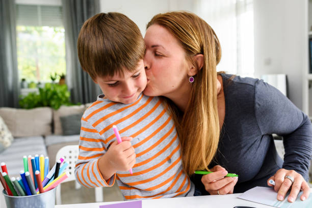 istock Mother teaching child at home how to write 1018310104