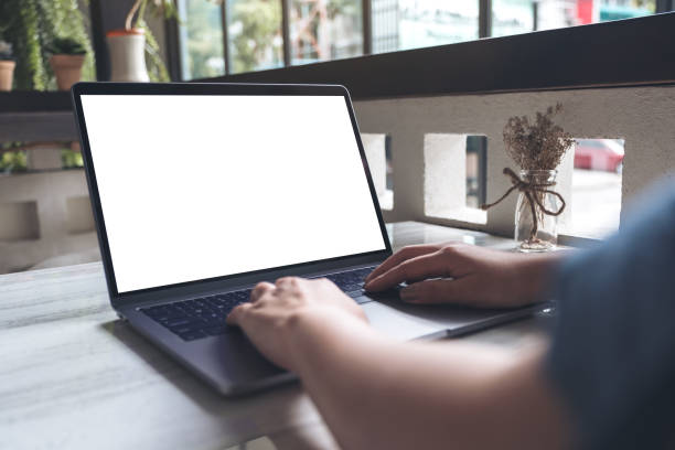 istock Mockup image of a woman using and typing at laptop with blank white desktop screen on table in cafe 1018310884