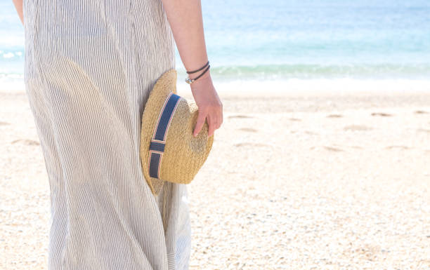 istock Girl with sun hat on a beach 1018311308