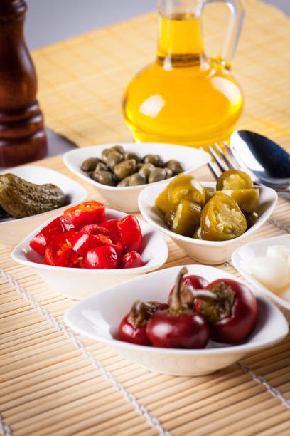 Various canned products in platter on a wooden table.