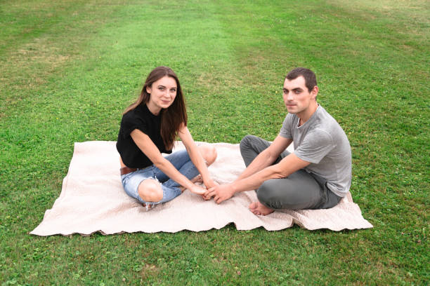 istock Couple sit on a blanket on the grass 1018322736