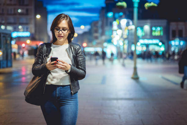 istock Woman texting outside at night 1018325654