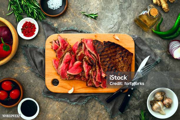 Grilled Skirt Steak Served On A Cutting Board Stock Photo - Download Image Now - Barbecue - Meal, Barbecue Grill, Flank Steak