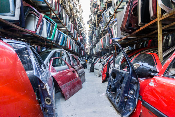 Old damaged cars on the junkyard waiting for recycling stock photo