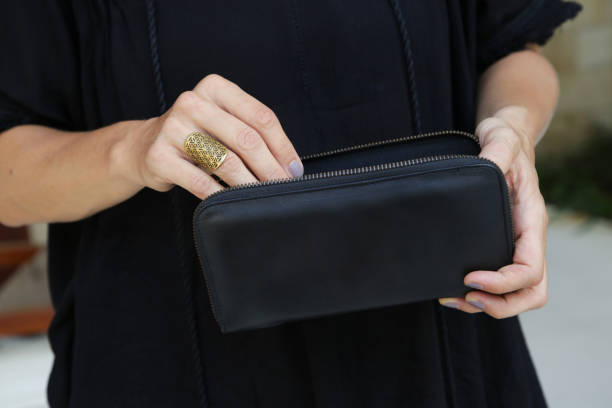 istock Woman holding black leather wallet 1018336610