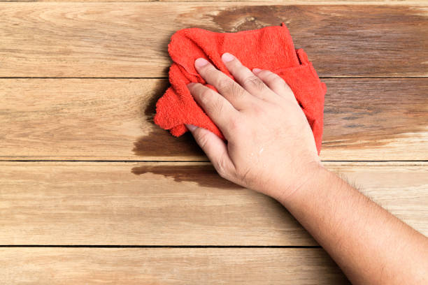 istock A man's hand Using red rags wipe the wooden floor. 1018336730