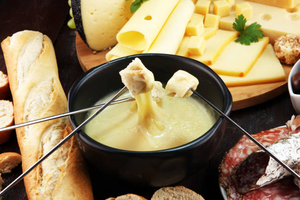 istock Gourmet Swiss fondue dinner on a winter evening with assorted cheese 1018337036