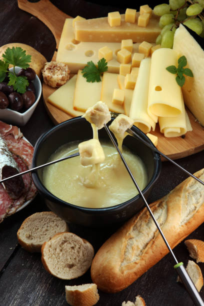 istock Gourmet Swiss fondue dinner on a winter evening with assorted cheese 1018337162