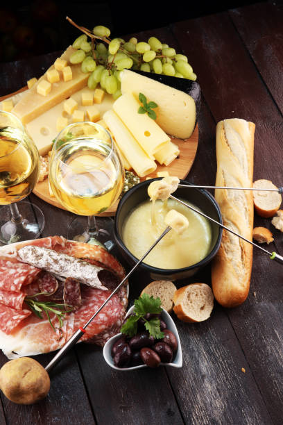 istock Gourmet Swiss fondue dinner on a winter evening with assorted cheese 1018339846