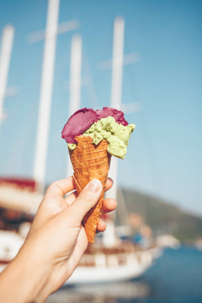 istock Woman's hand holding ice cream. 1018340790