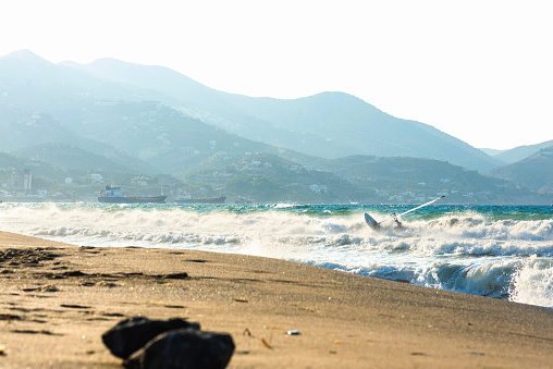 Windsurfers in the sea on Crete on sunset. Windsurfing in Heraklion. Greece on sunset