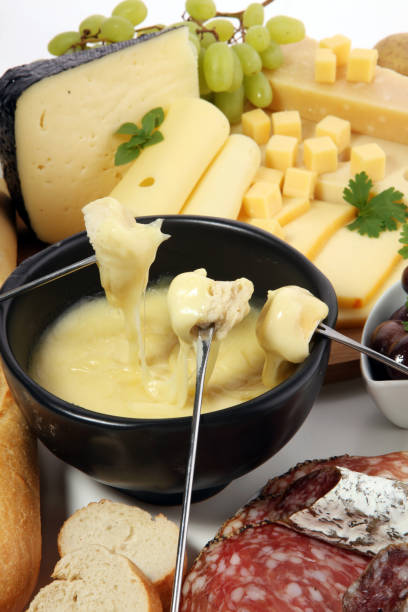 istock Gourmet Swiss fondue dinner on a winter evening with assorted cheese 1018347488