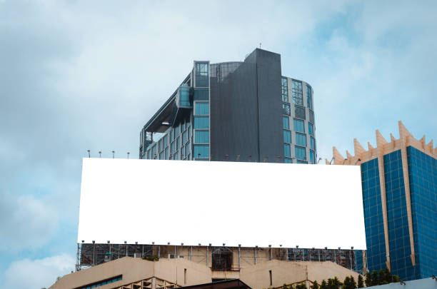 istock blank billboard white canvas on top of building in city with empty copy space for display advertisement text template at outdoor in town. 1018354056
