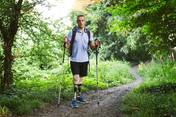 istock Hiker with artificial legs enjoin nature in forest 1018354486