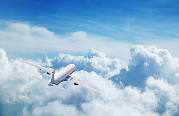 Commercial airplane flying above clouds Back view of commercial airplane flying above clouds. Copyspace for text fighter plane photos stock pictures, royalty-free photos & images