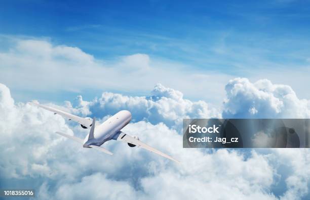 Commercial Airplane Flying Above Clouds Stock Photo - Download Image Now - Airplane, Sky, Air Vehicle